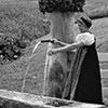 Frau in Walsertracht am Brunnen